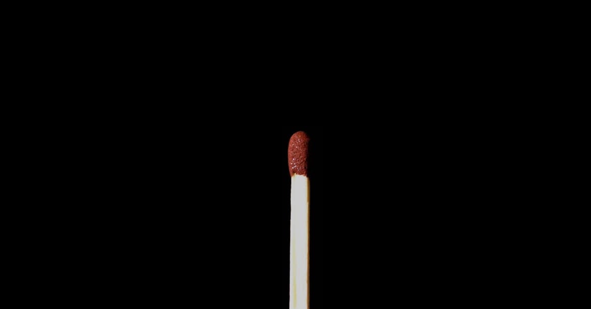 A single matchstick against a black background, emphasizing simplicity and contrast.